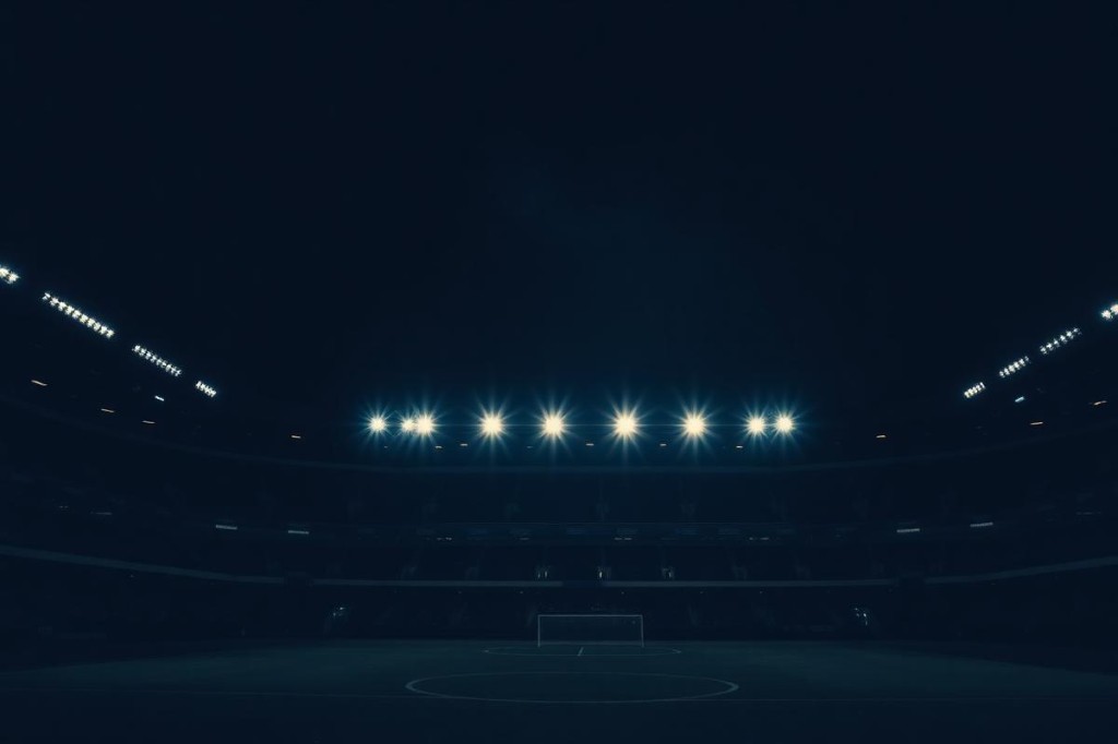 Floodlit football stadium at night